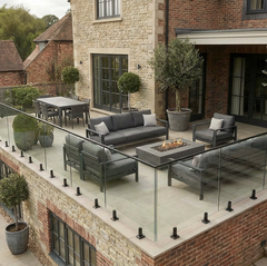 Frameless glass balustrade supported by black stainless steel spigots, ideal for decking, patios, and balcony areas