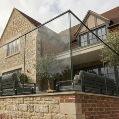 Modern black spigot and glass balustrade system designed for UK outdoor installations, including decking and terraces