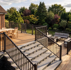 Black aluminium balustrade enclosing a patio and continuing down a flight of stairs