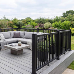 Black aluminium balustrade around a small raised decking patio