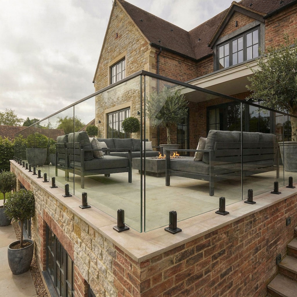 Black spigot glass balustrade system used on garden decking, providing safety without obstructing views
