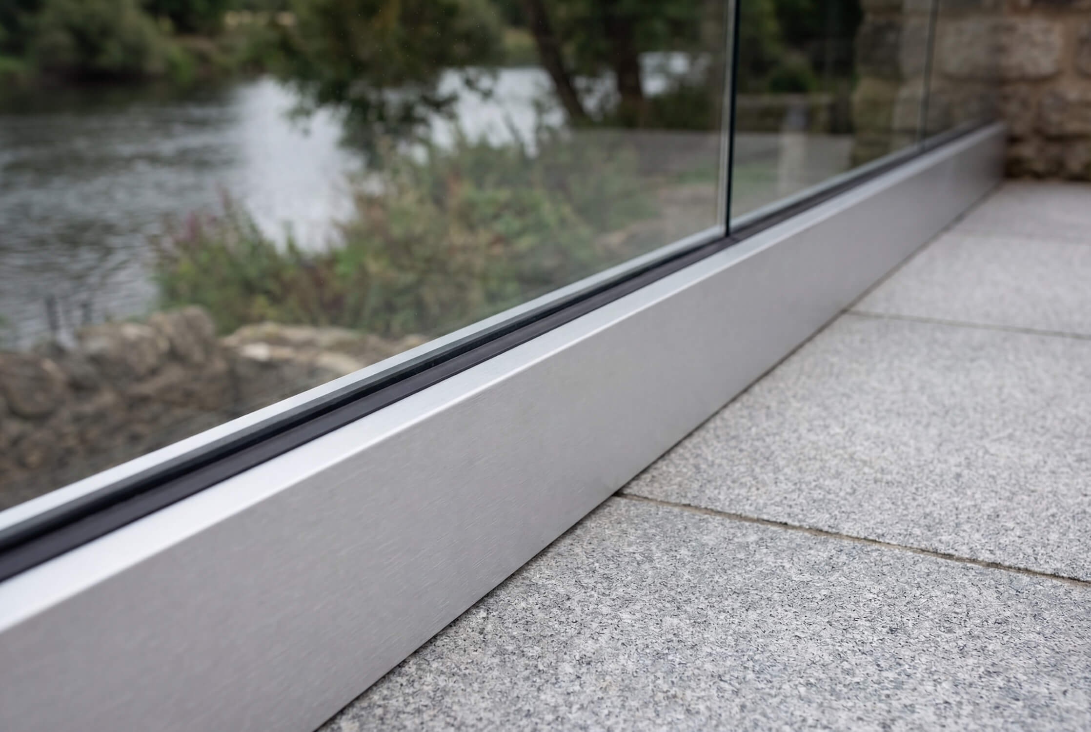 Close-up of fully frameless silver glass balustrade installed on a residential balcony