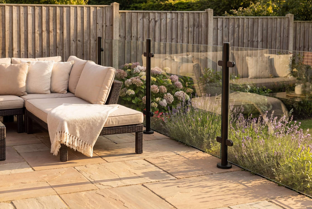 Semi-frameless glass balustrade system in black, combining clear glass panels with a slim framed finish for modern outdoor spaces