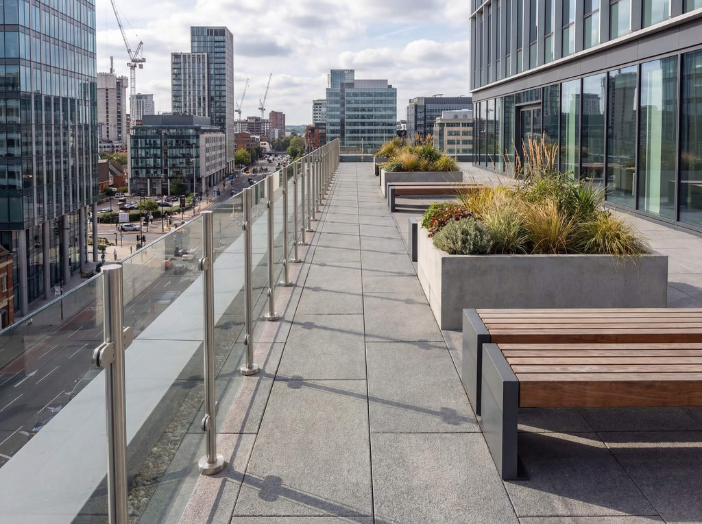 Semi-frameless glass balustrade installed on a city balcony, combining slim framing with clear glass for modern urban living