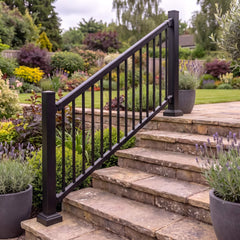 Black aluminium stair balustrade with angled rails and stair brackets fitted alongside stone garden steps
