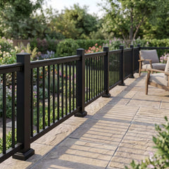 Black aluminium balustrade along a stone patio edge in natural sunlight