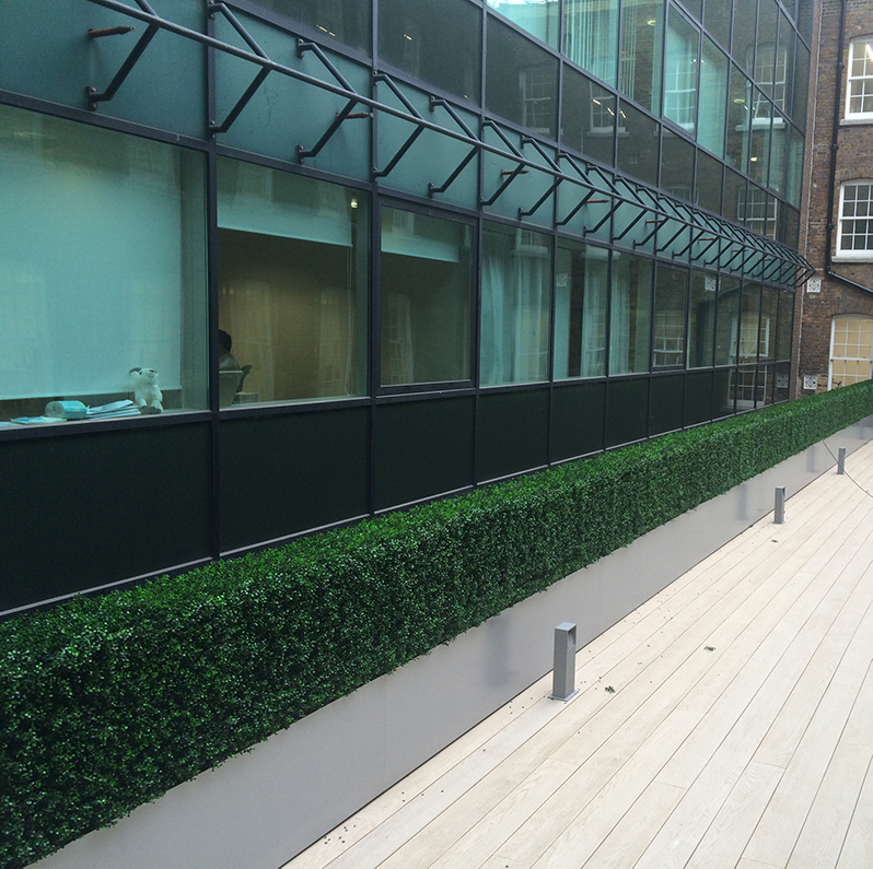 artificial boxwood hedge panels used for a faux hedge
