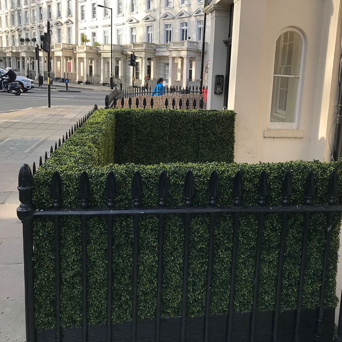 artificial topiary hedge tiles used to create a faux hedge