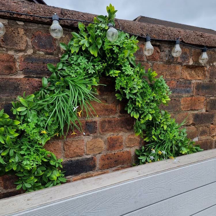 mixed foliage artificial hedge tiles used to create trellis design