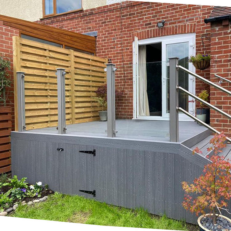 Grey Composite decking with stairs and glass balustrades