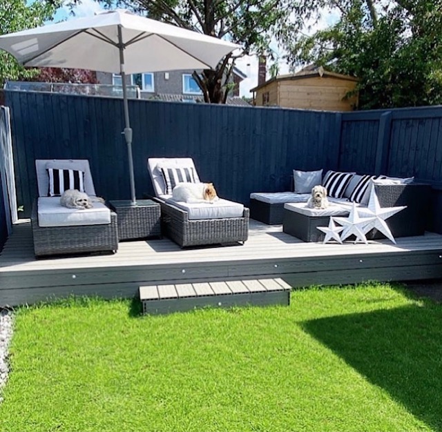 decking with sun beds on it and a large sun shade