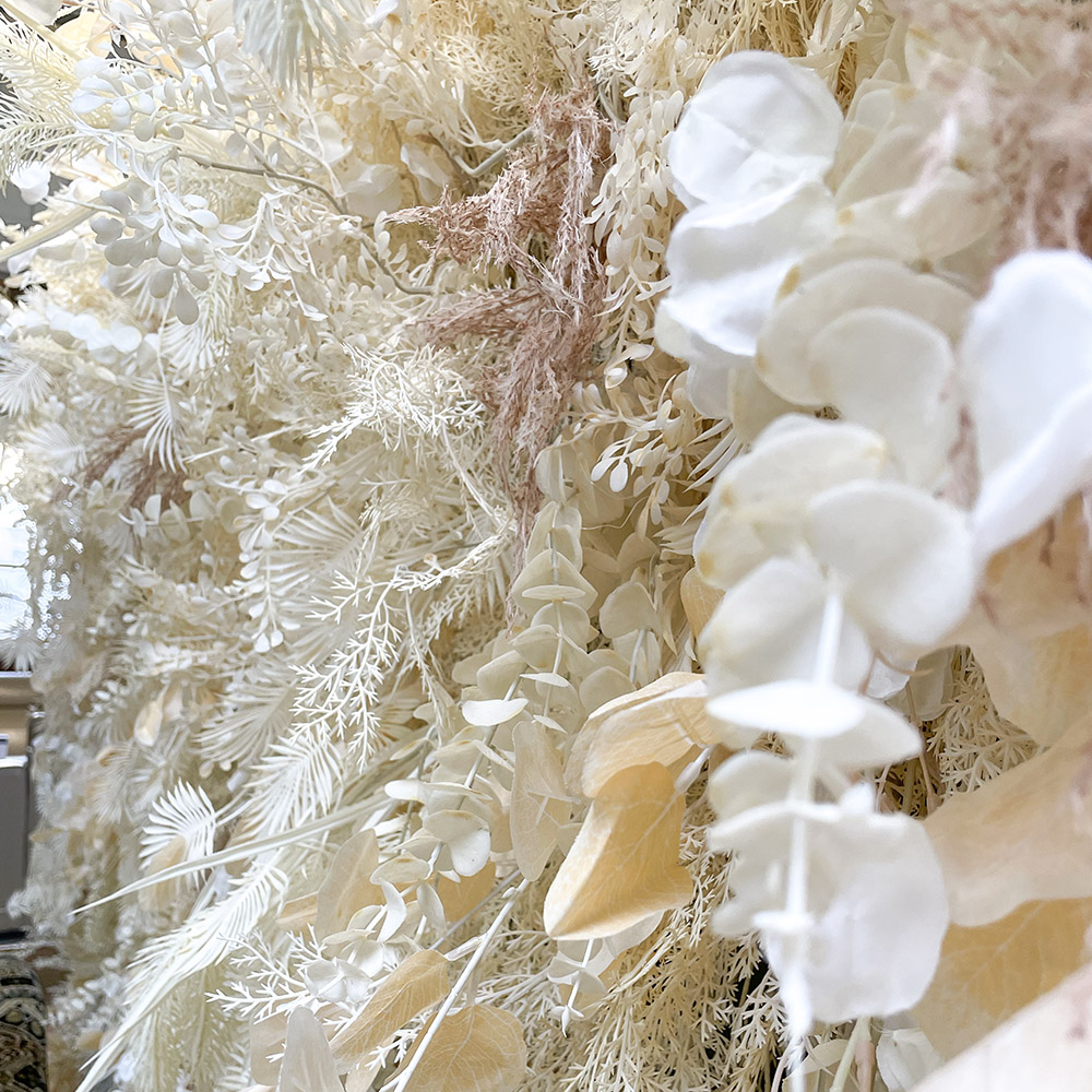 close up of the artificial foliage on a boho flower wall