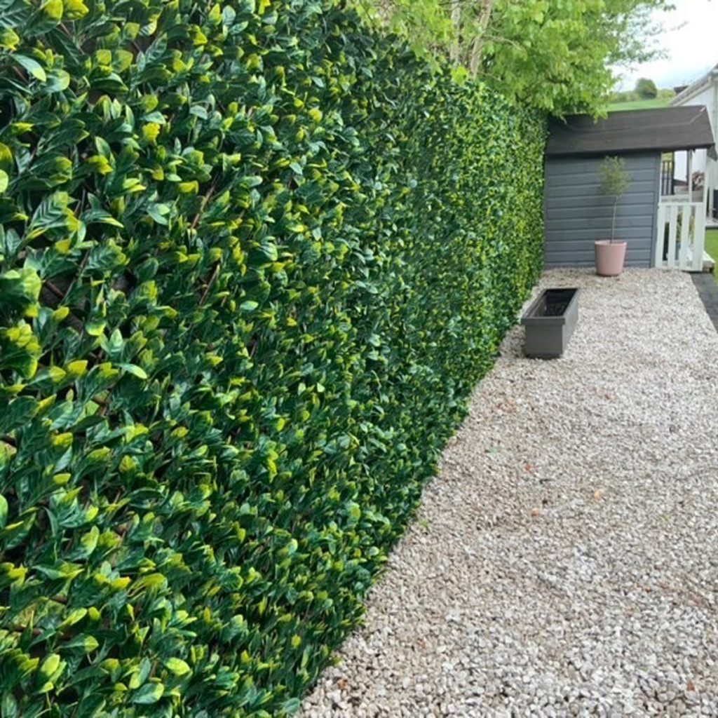 extendable hedge screening on a wooden fence to provide privacy