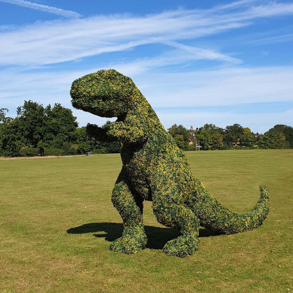American Express using artificial hedge tiles to create a giant dinosaur 